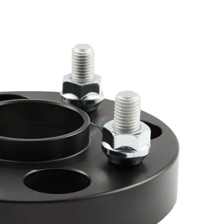 Close view of wheel spacer center pilot, studs and fastening nuts